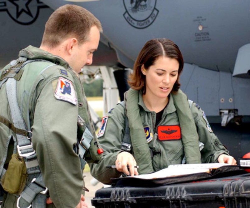 Capt__Nicole_Malachowski__F-15E_female_pilot__looks_over_checklists_before_flying_a_sortie_1763646018.jpg